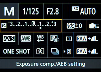 How do I change exposure compensation in manual mode?