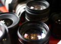 What are the disadvantages of a zoom lens?
